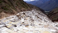 Greetings From… Maras, Peru Tucked away in a deep canyon in Peru’s Sacred Valley are the Maras salt flats (Salineras de Maras). Only about 25 miles (40 km) north of Cuzco, the only access to the area is via a treacherous dirt roadway…without any guardrails! If you can white-knuckle the trip down however, it’s well...