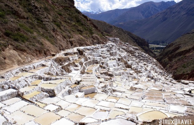 Tucked away in a deep canyon in Peru’s Sacred Valley are the Maras salt flats (Salineras de Maras). Only about 25 miles (40 km) north of Cuzco, the only access to the area is via a treacherous dirt roadway…without any guardrails! If you can white-knuckle the trip down however, it’s well...